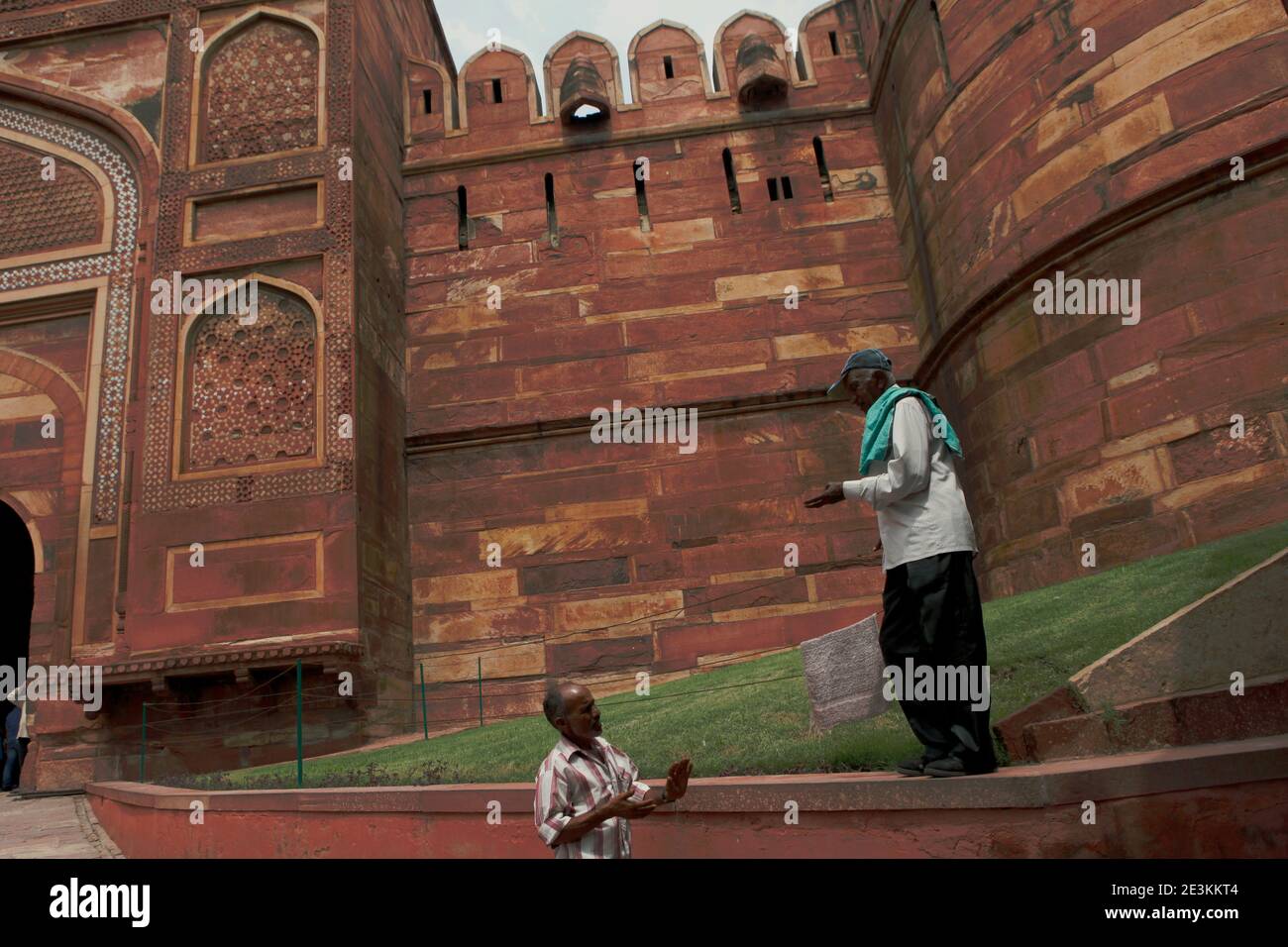 Men having conversation at the lawn before the Amar Singh Gate of Agra Fort in Agra, Uttar Pradesh, India. Stock Photo