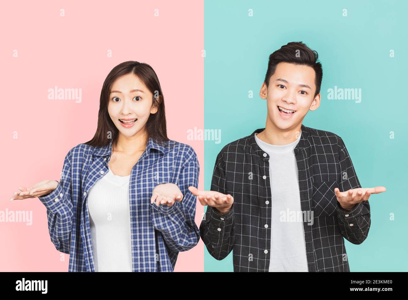 young asian couple having confused looks and shrugging shoulders Stock Photo