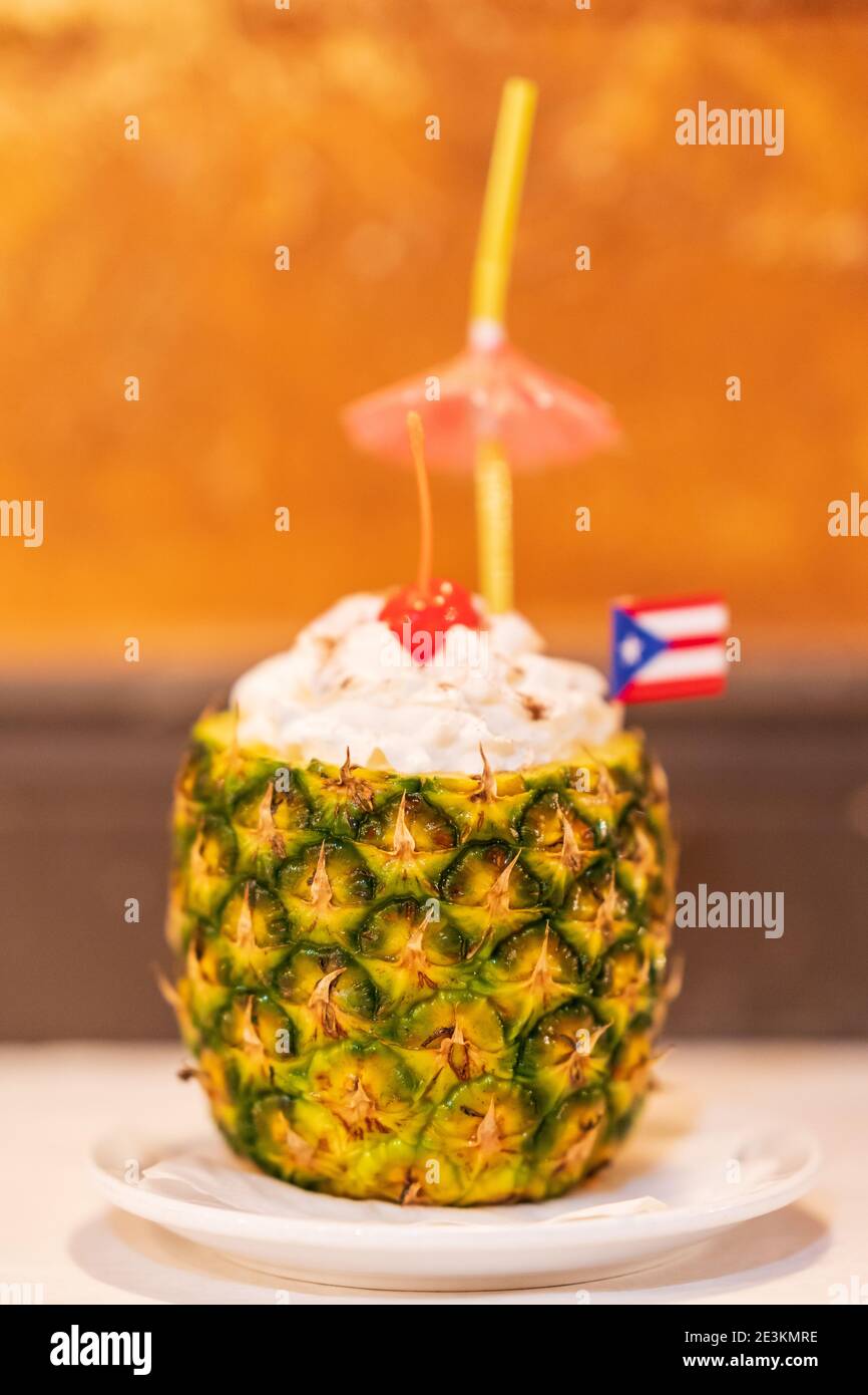 Delicious Piña Colada Cocktail Garnished with an Umbrella and Puerto Rican Flag. Stock Photo