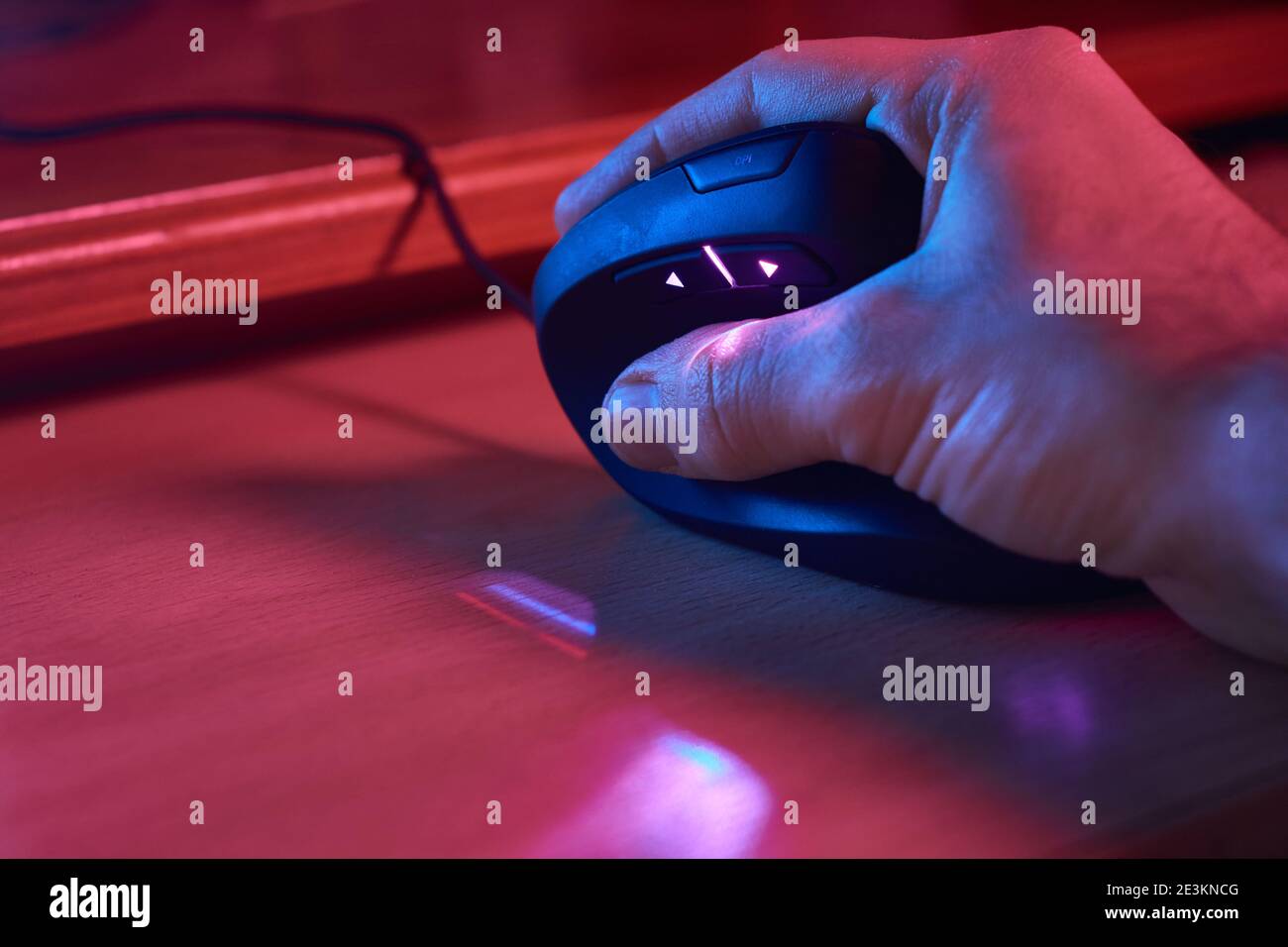 Male young hand lying on ergonomic gamer vertical mouse for computer