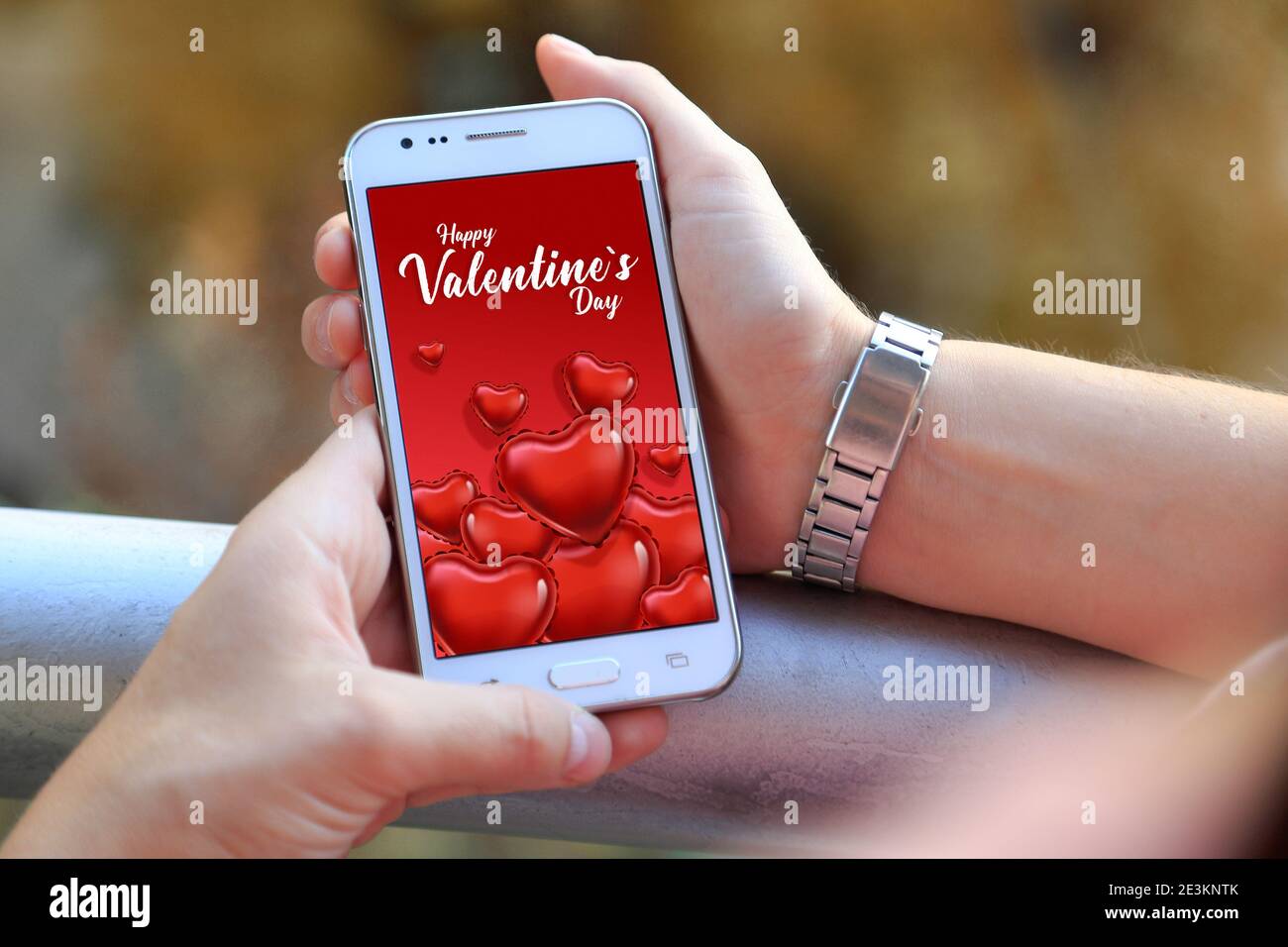 Valentines Day digital online card in the screen of mobile phone. Stock Photo