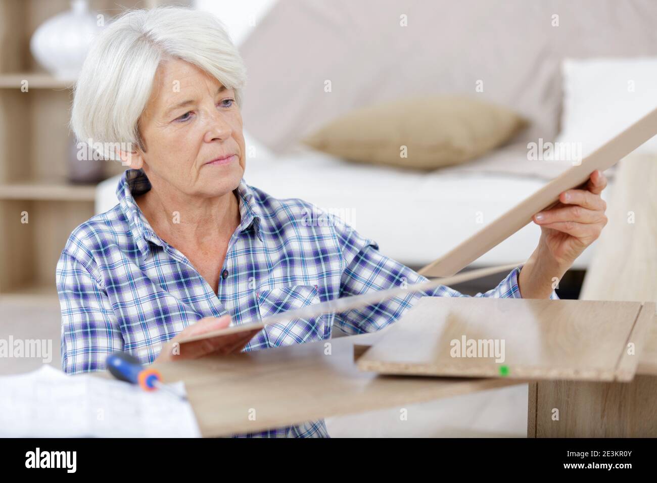 a senior woman fixing furnitures Stock Photo Alamy