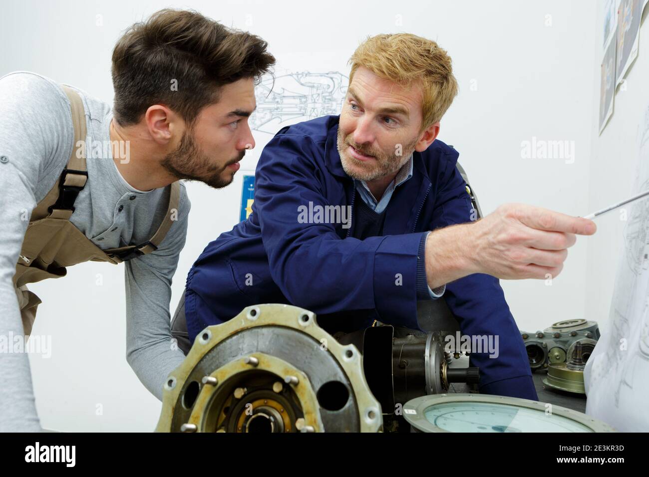 two male engineers working with new project on drawing board Stock