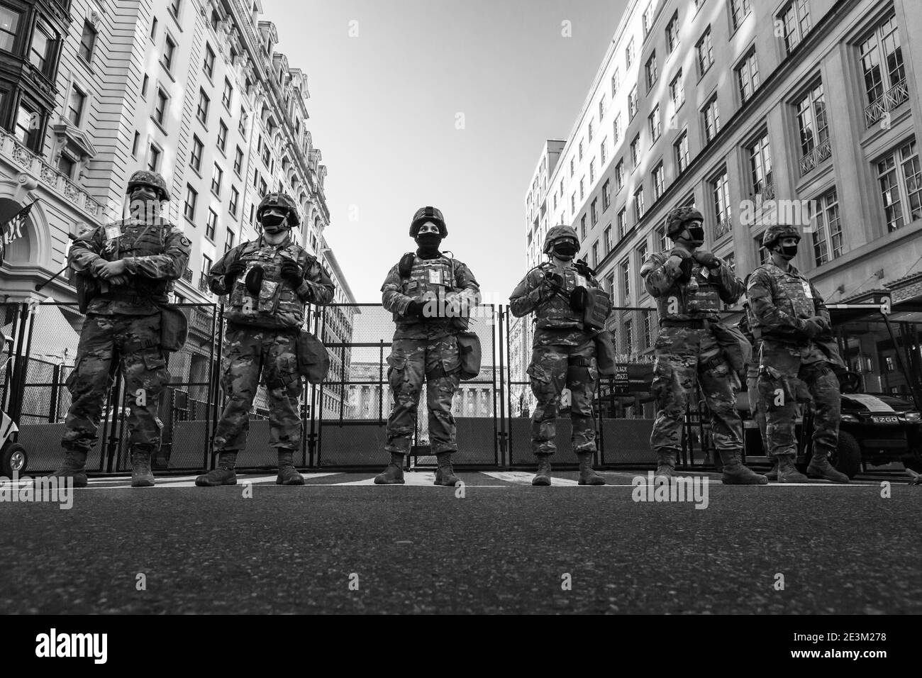 Washington, DC, USA, 19 January, 2021.  Pictured: National Guard troops stand in front of a jersey wall and steel fence blocking access to the Department of the Treasury in advance of the presidential inaguration.  Preparations and security measures were instituted far earlier than usual due to the threat of violence posed by Trump supporters, white supremacists, and other right-wing extremists.  Credit: Allison C Bailey/Alamy Live News Stock Photo