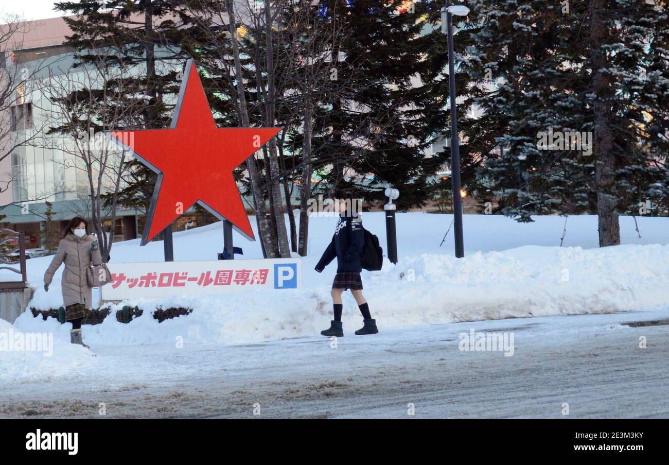 A Japanese Scholl girl walking on an icy  road in Sapporo, Japan. Stock Photo