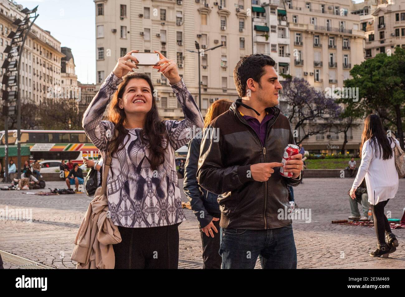 A tourist takes a selfie with her mobile phone. Known for its eclectic European architecture and a rich cultural life, Buenos Aires, with a population of about 3 million people (16 if you consider the Greater Buenos Aires) is thriving and full of life, a city with a rhythm of its own. Stock Photo