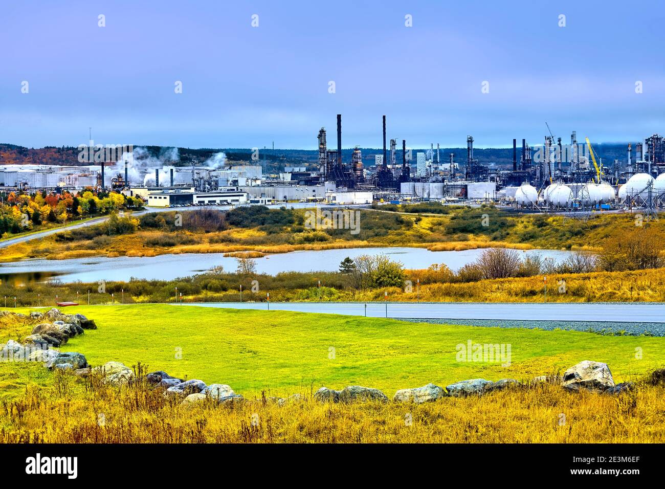 An autumn image of the large Irving Oil Refinery in rural Saint John New Brunswick Canada with the local foliage turning the bright colors of autumn. Stock Photo