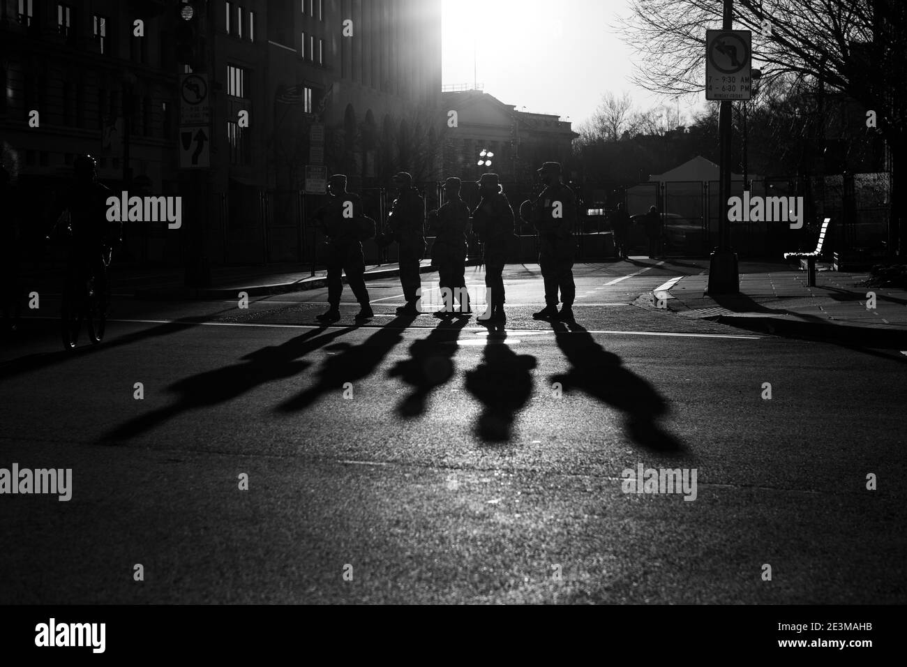 Washington, DC, USA, 19 January, 2021.  Pictured: National Guard troops cast long shadows on the pavement in the afternoon sun.  These are some of the 25,000 troops deployed to Washington for Joe Biden's inauguration. Preparations and security measures were instituted far earlier than usual due to the threat of violence posed by Trump supporters, white supremacists, and other right-wing extremists.  Credit: Allison C Bailey/Alamy Live News Stock Photo