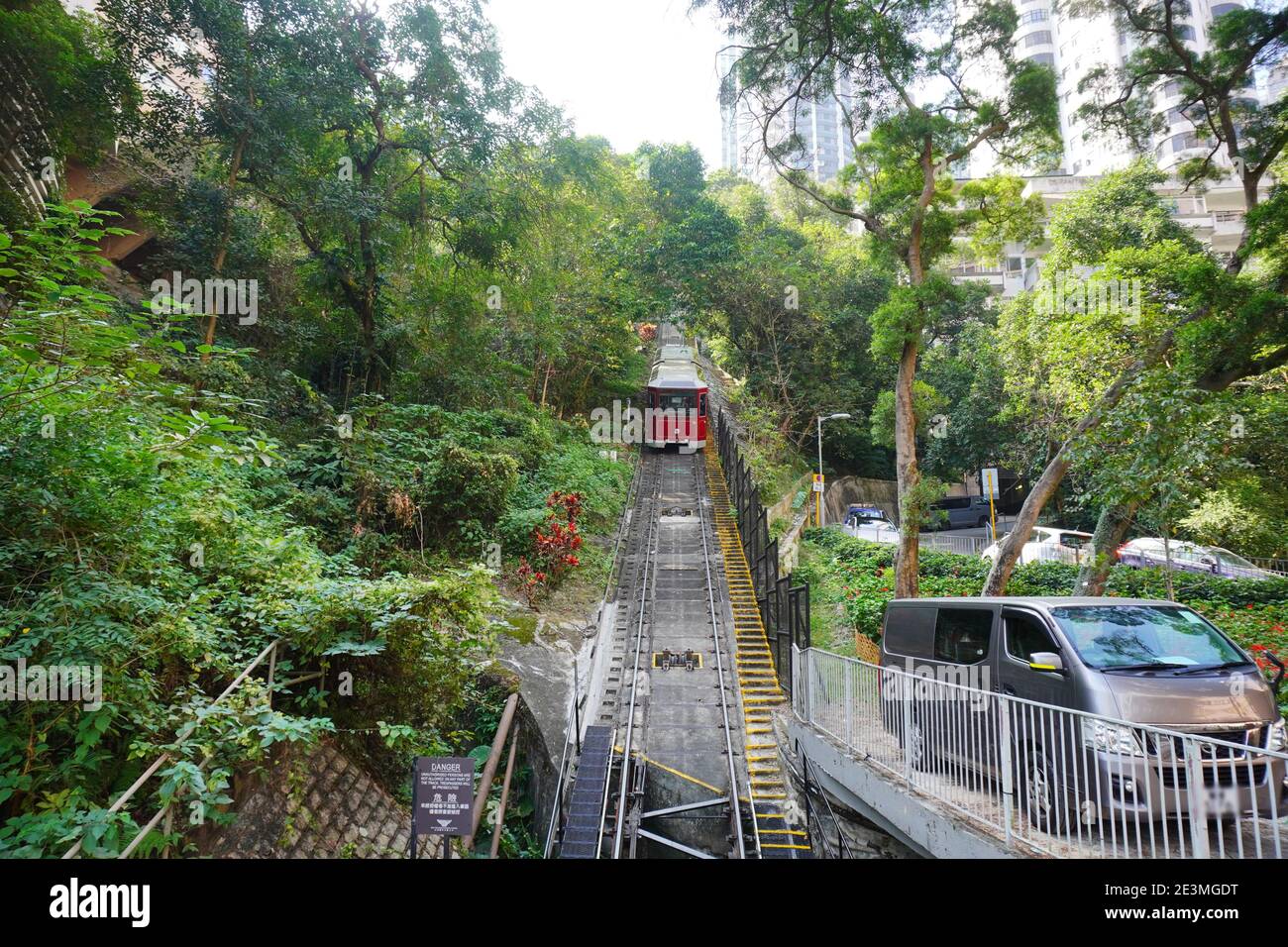 The Peak Tram climbing up the steep hill, a Funicular Railway and Landmark of Hong Kong Stock Photo