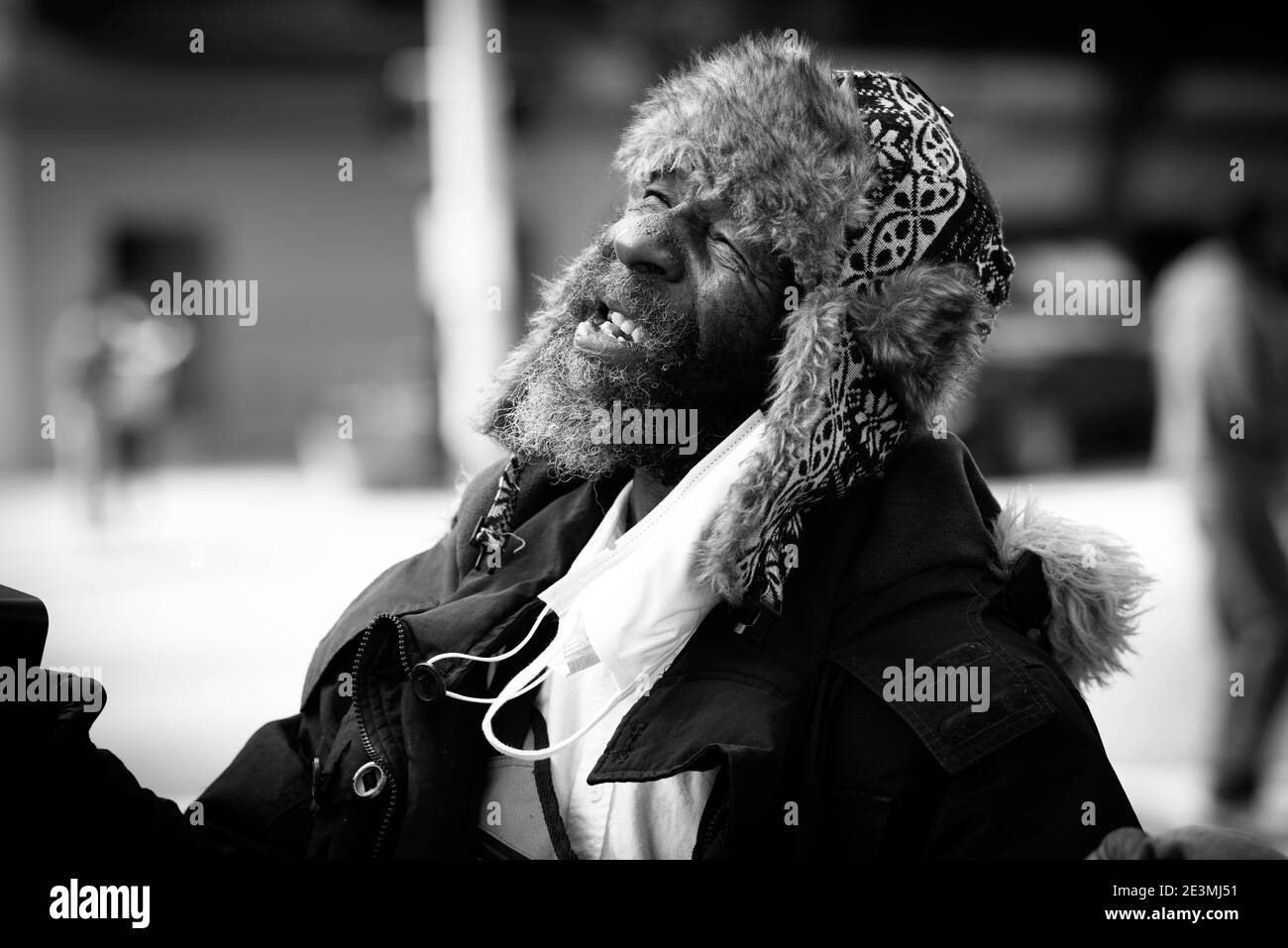 Atlanta, Georgia, USA. January 19, 2021: A homeless and unemployed man finds joy in the moment with others in the same situation. The city is experiencing a growing homeless population in the city, which recently was estimated at well over 3,000 in the past year. Social workers who monitor the situation said there are several reasons for more people on the streets, including the large Peachtree-Pine shelter closing in 2017, the coronavirus pandemic, and 'mental health issues going through the roof. Credit: ZUMA Press, Inc./Alamy Live News Stock Photo