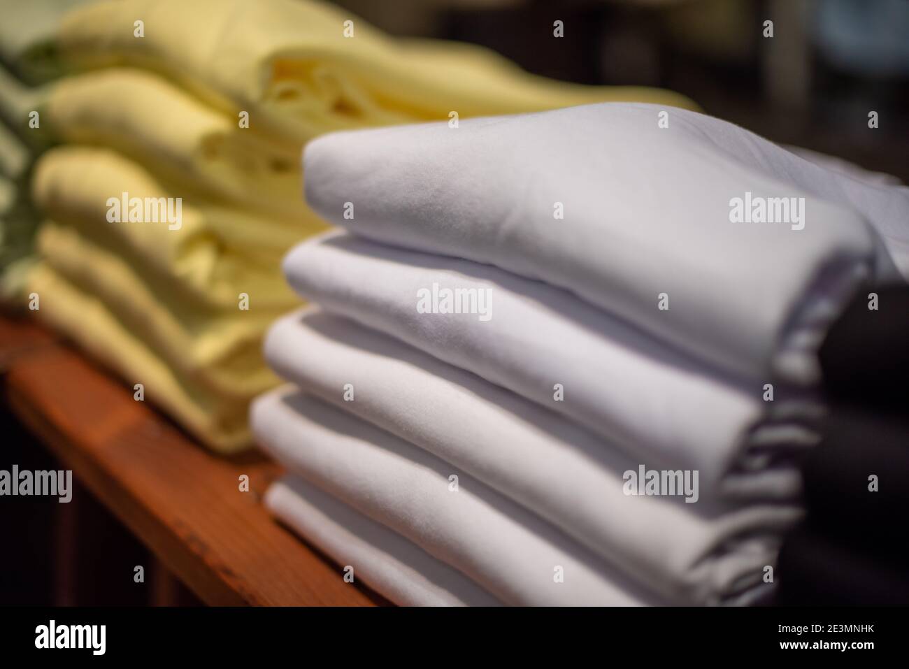 white and yellow sweaters stacked on top of each other Stock Photo Alamy