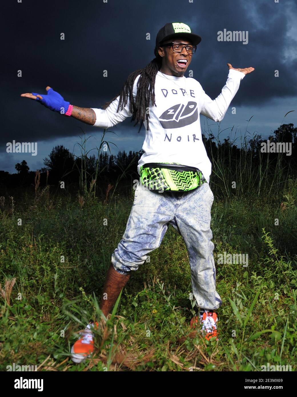 MIAMI, FL - AUGUST 08: Lil Wayne in the weeds. Dwayne Michael Carter, Jr. (born September 27, 1982), known by his stage name Lil Wayne, is an American rapper from New Orleans, Louisiana. In 1991, at the age of nine, Lil Wayne joined Cash Money Records as the youngest member of the label, and half of the duo, The B.G.'z, with fellow New Orleans-based rapper B.G. In 1996, Lil Wayne joined Southern hip hop group Hot Boys, which also included rappers Juvenile, B.G., and Young Turk. Hot Boys debuted with Get It How U Live! that same year. Lil Wayne gained most of his success with the group's major Stock Photo