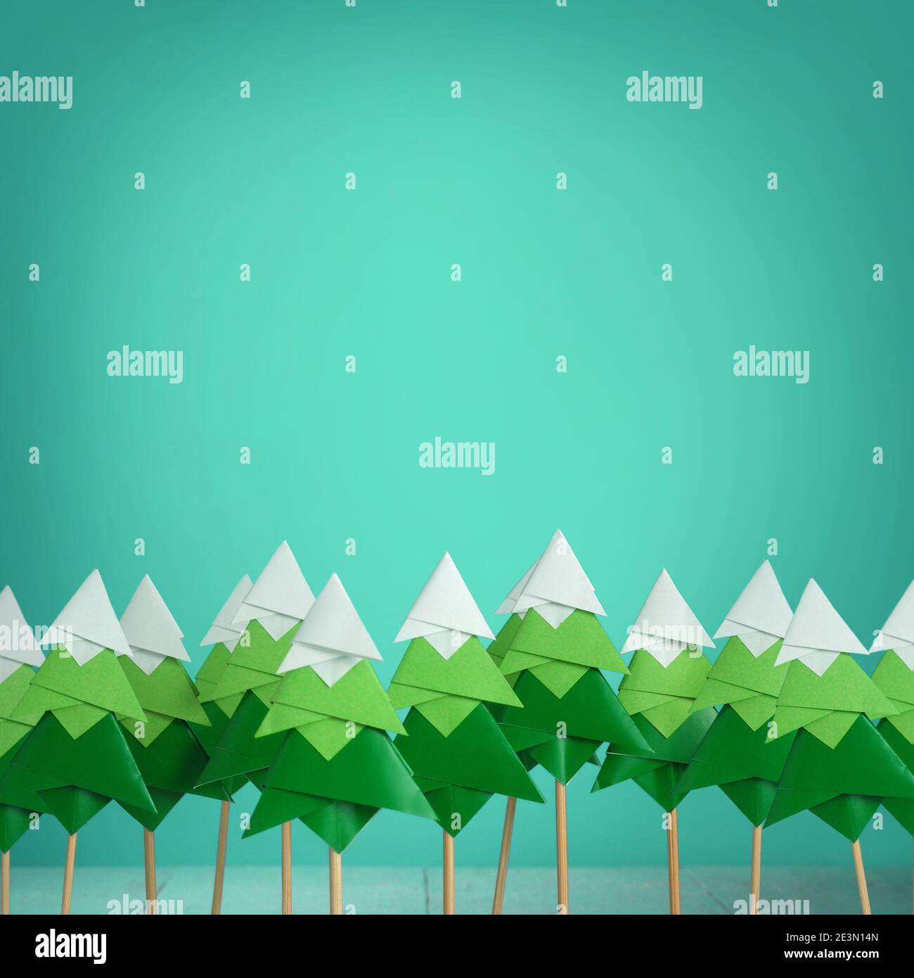 Handmade origami paper craft Christmas tree on light blue paper Stock ...