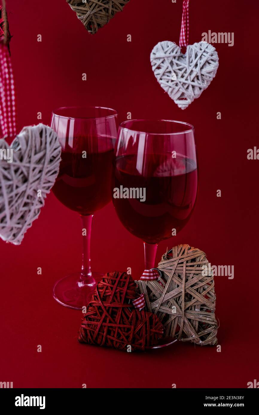 Two glasses of red wine and decorative hearts. Love romance. Couple ...