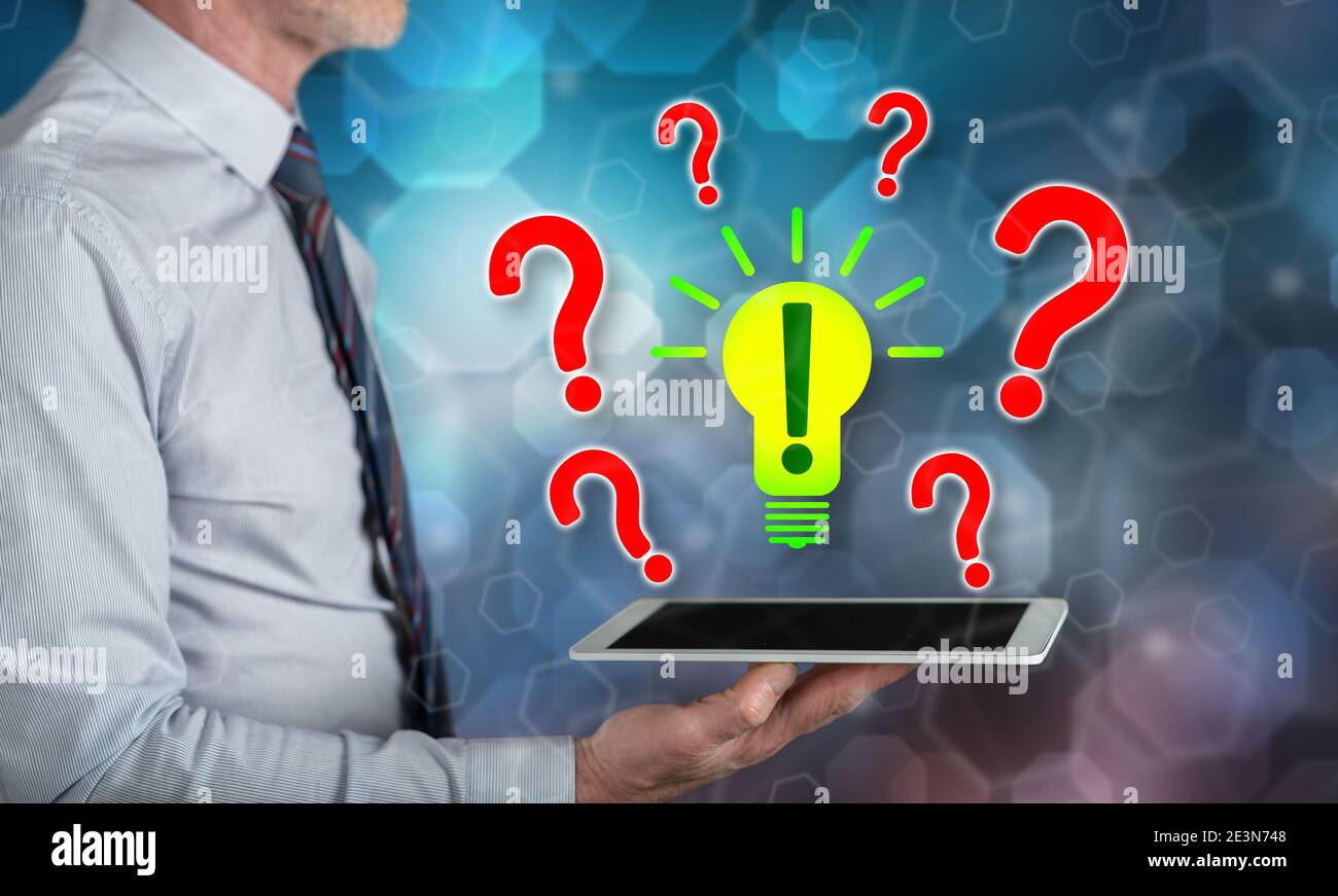 Problem solving concept above a tablet held by a man Stock Photo