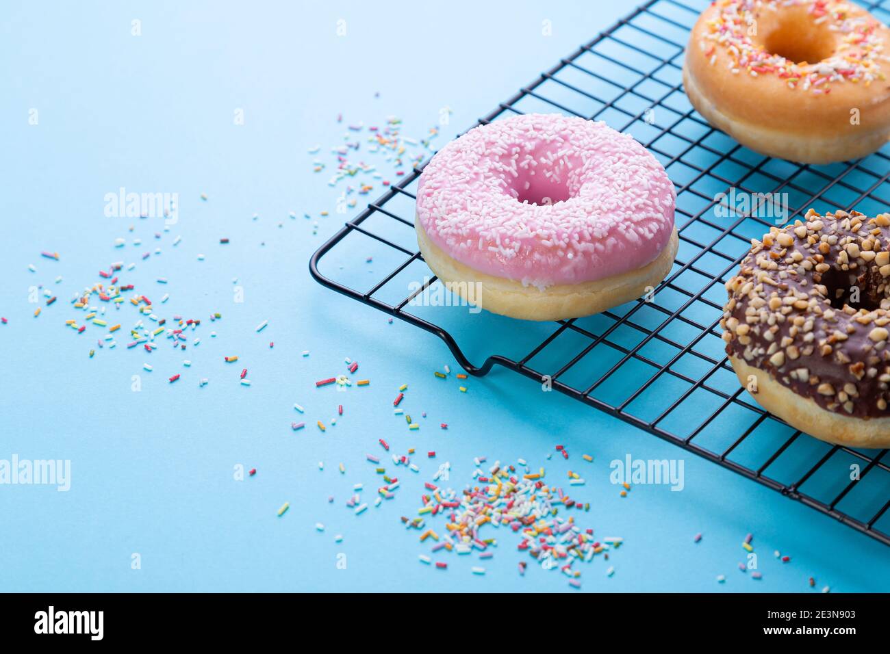 Mixed donuts on grid on blue background. With copy space Stock Photo ...