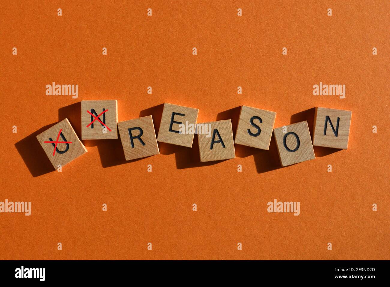 Unreason, with prefix Un crossed out, leaving the opposite word Reason Stock Photo