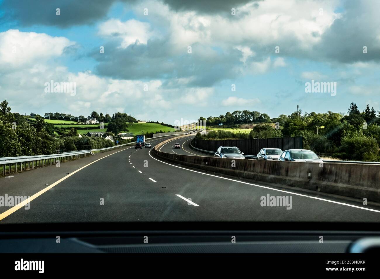 Pleasant view from inside a car of the lush green landscape along the M7 Motorway toward Dublin Ireland Stock Photo