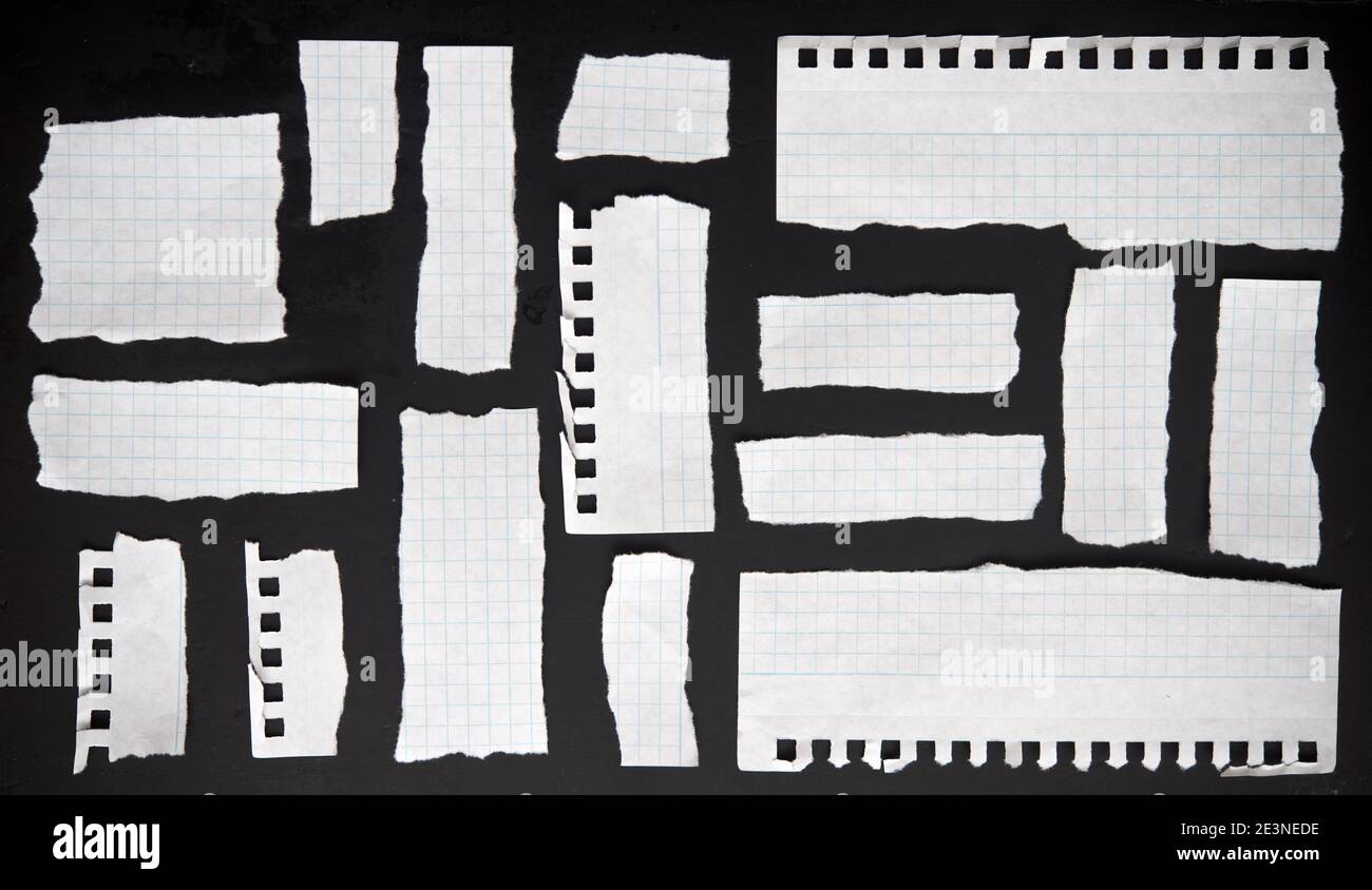 Torn papers on a black background Stock Photo