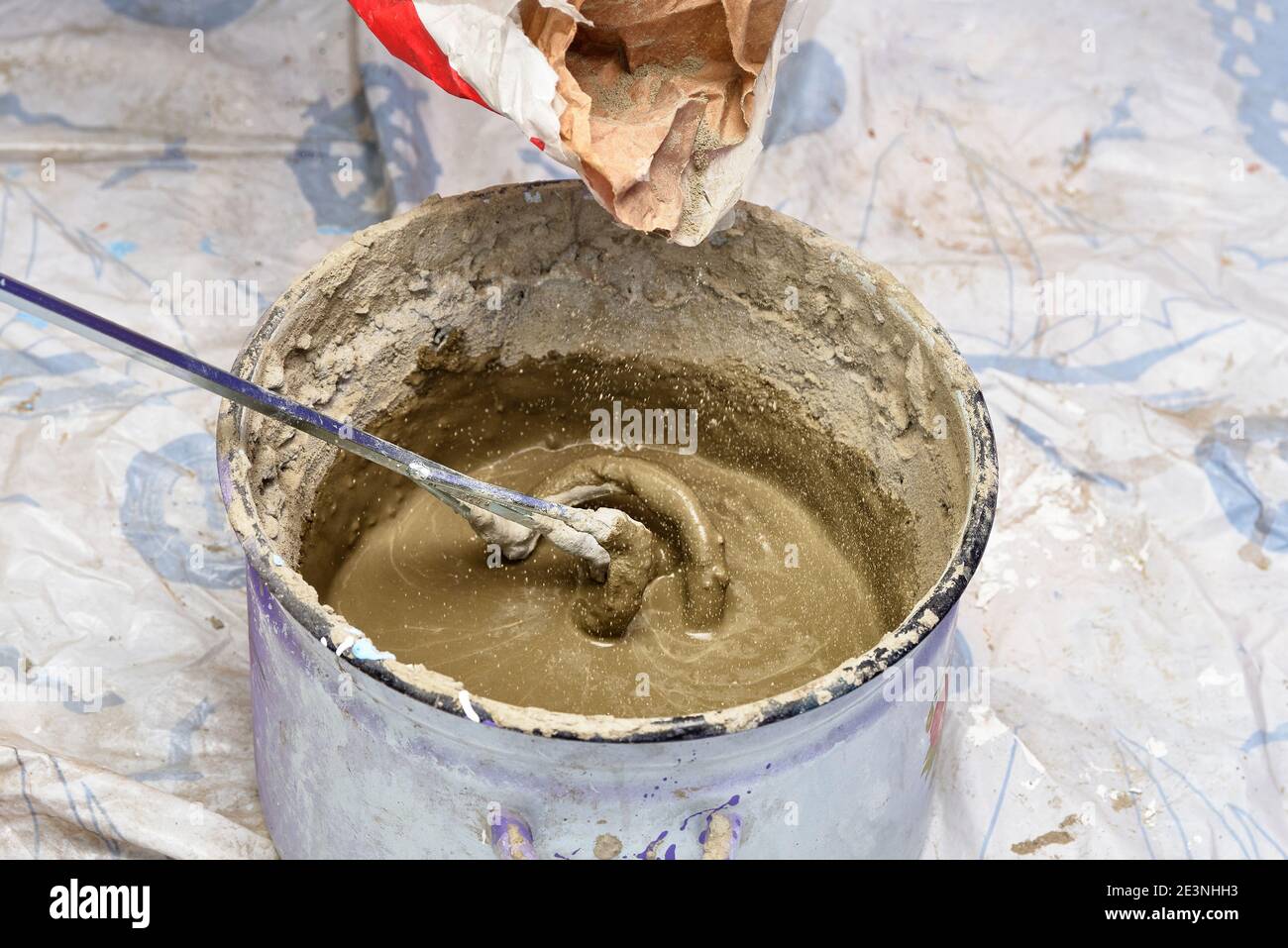 kneading cement mortar in saucepan. preparation for repair Stock Photo