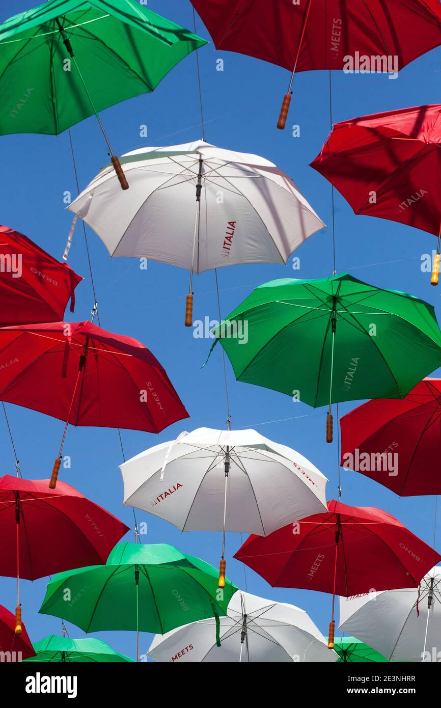 Colorful umbrellas in blue sky in Italy colors Green red white Stock Photo