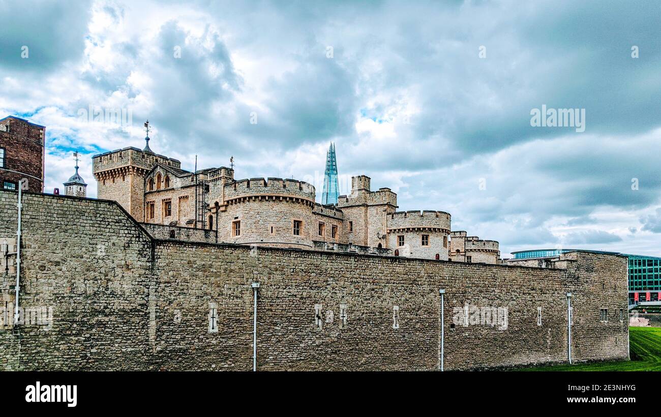 Tower of London with the Shard in the background skyline on a cloudy day. Stock Photo