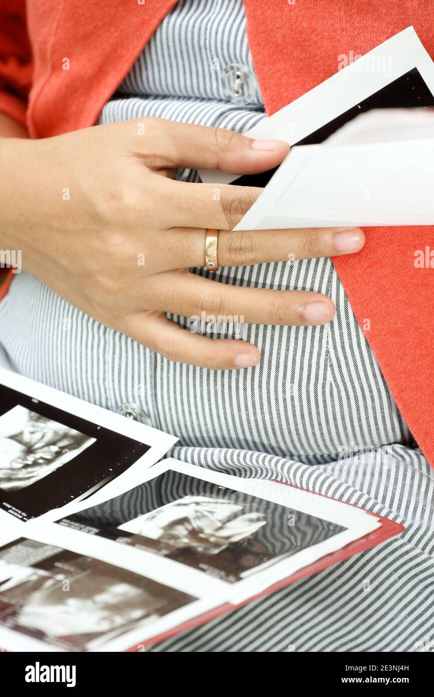 pregnant woman and her ultrasonography scan print outs Stock Photo - Alamy
