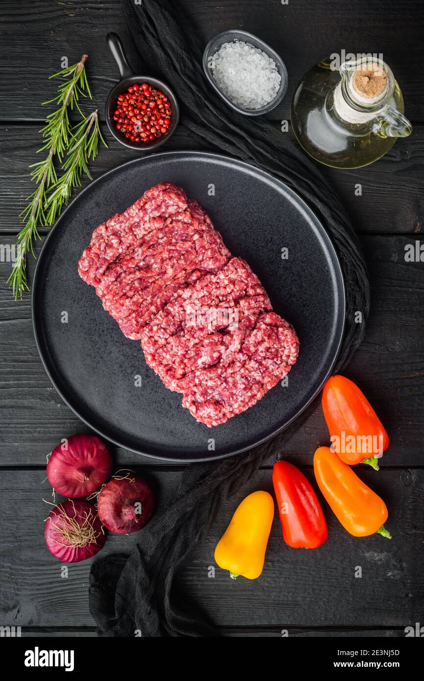 Organic Raw Grass Fed, Ground Beef, on black wooden table background