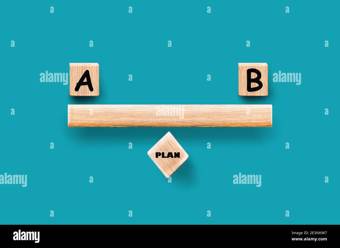Plan A or Plan B in wooden blocks, Front View, Turquoise background. Choices Balance Concept. Stock Photo