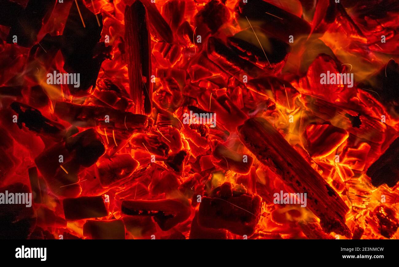 Burning firewood, glowing coals, fire and flames closeup photo. Burning coal for a barbecue Stock Photo