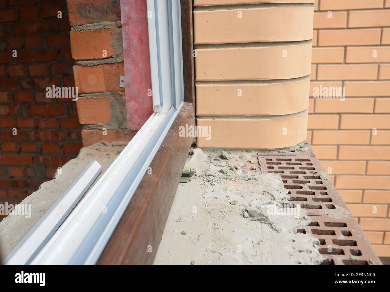 A closeup on upvc window installation white inside and brown outside