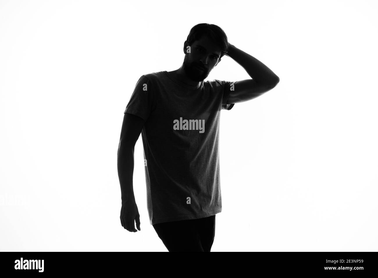 the dark silhouette of a man gesticulate with his hands white ...