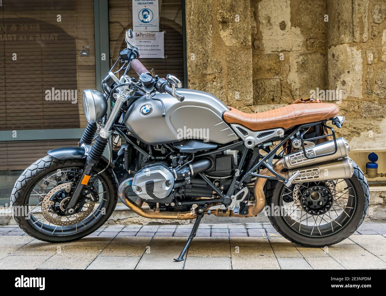 BMW motorcycle on a cobbled street in a french city. Stock Photo