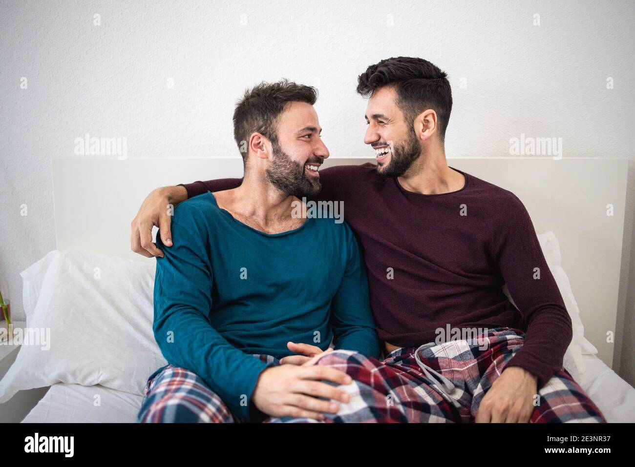 Happy gay men couple having tender moments together at home - Focus on right man Stock Photo