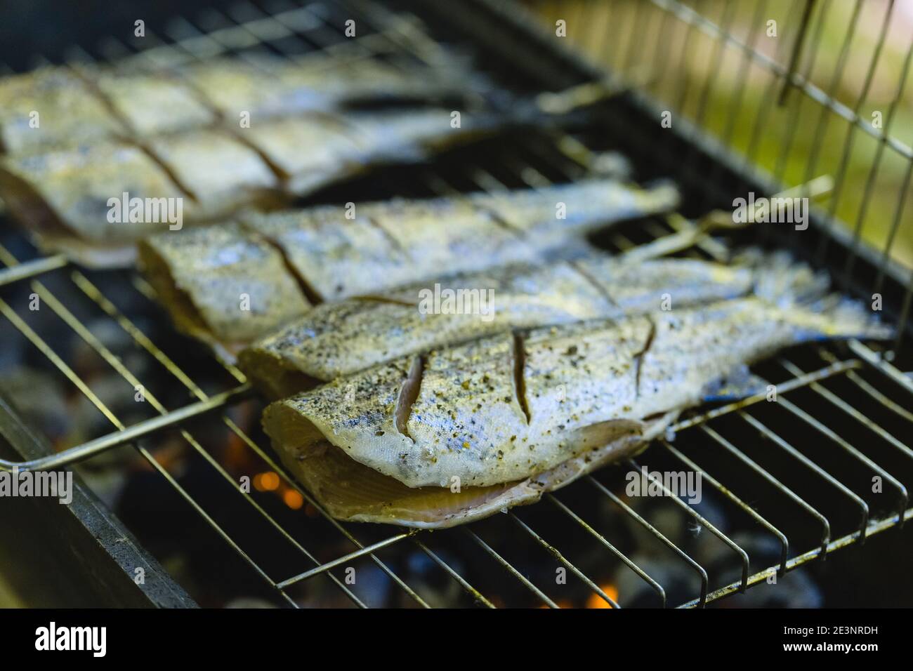 Preparing fresh trout fish on charcoal grill for Summer picnic party Stock Photo Alamy