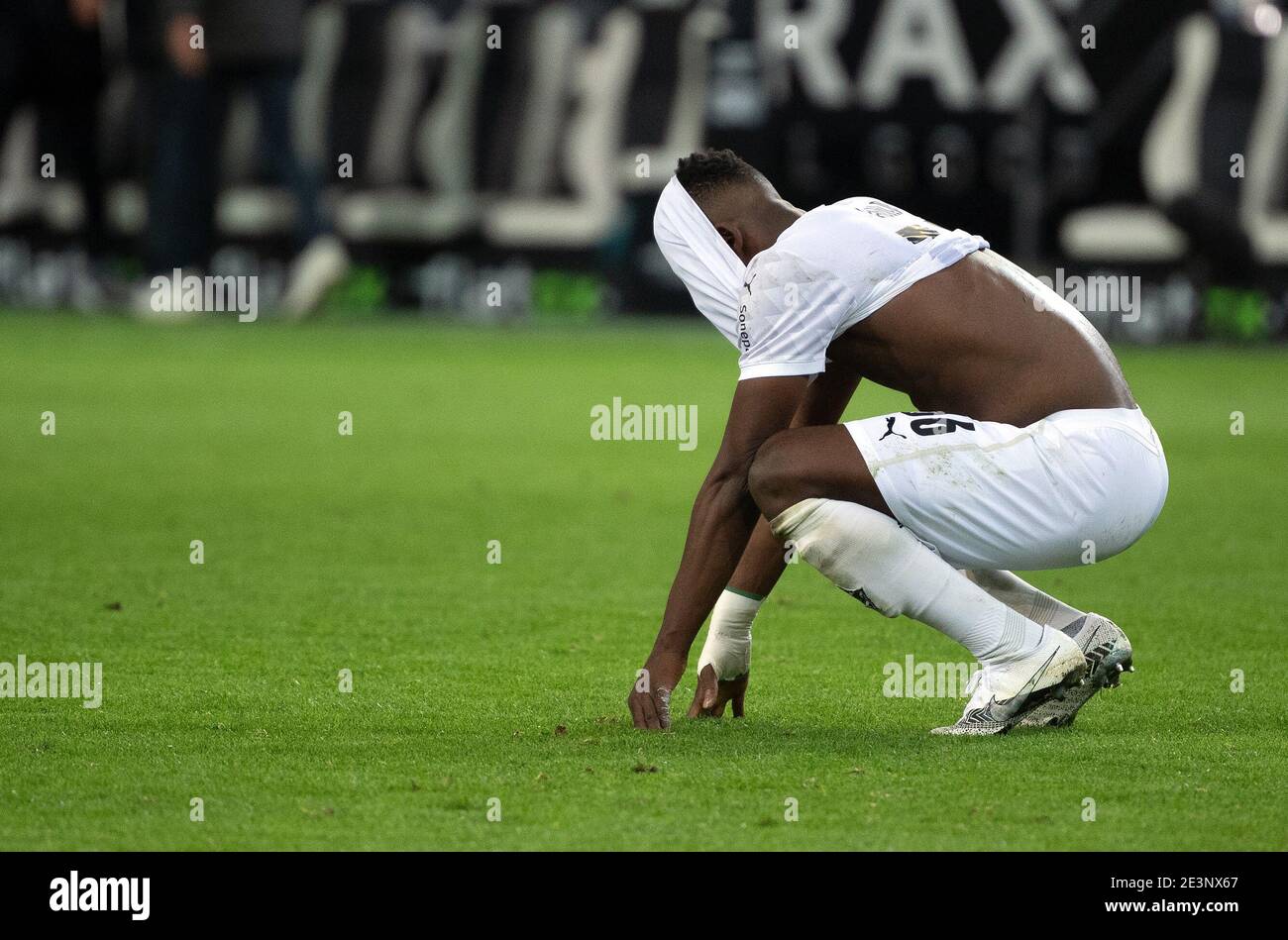 FILED - 21 November 2020, North Rhine-Westphalia, Mönchengladbach:  Football: Bundesliga, Borussia Mönchengladbach - FC Augsburg, Matchday 8 at  Borussia-Park. Gladbach's Breel Embolo squats on the grass after the 1:1  and has pulled