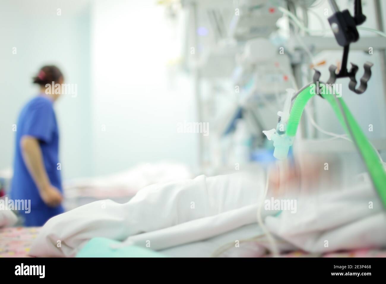 Female medical worker on the baby's bedside in the NICU, unfocused background. Stock Photo