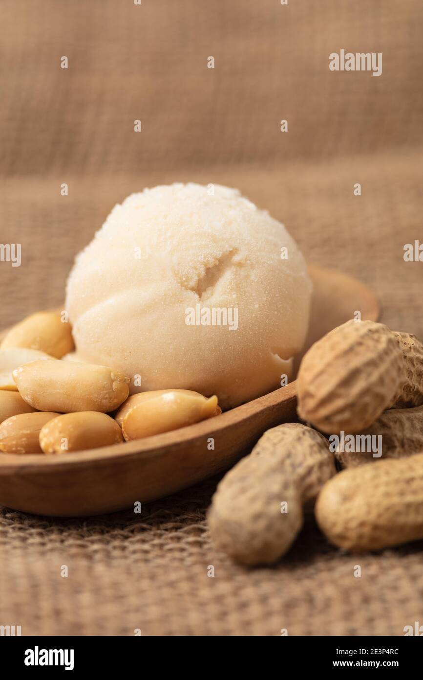 Homemade scoop of peanut ice cream or peanut butter ice cream with peanuts Stock Photo