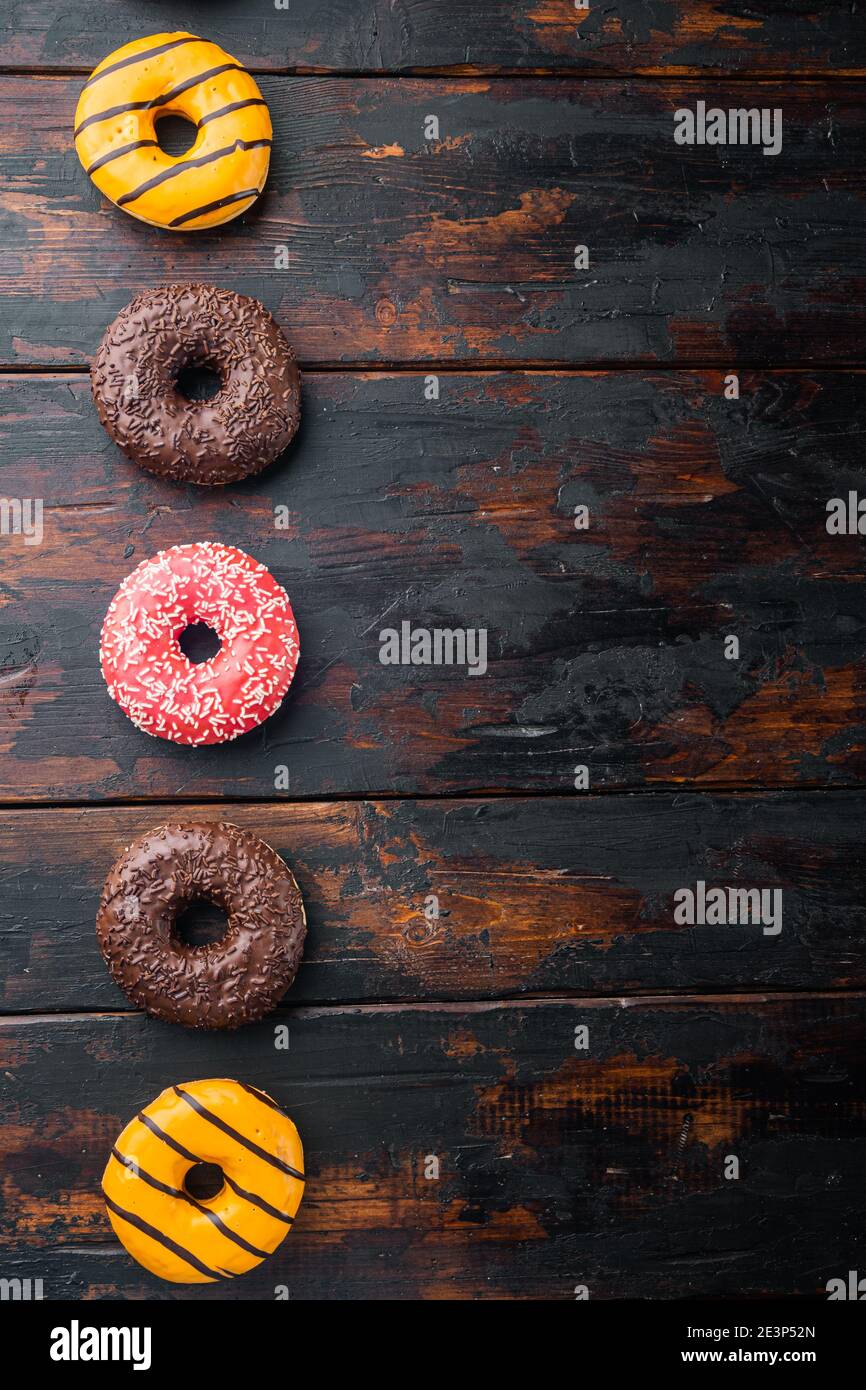 Delicious glazed donuts set, on old dark wooden table background, top ...