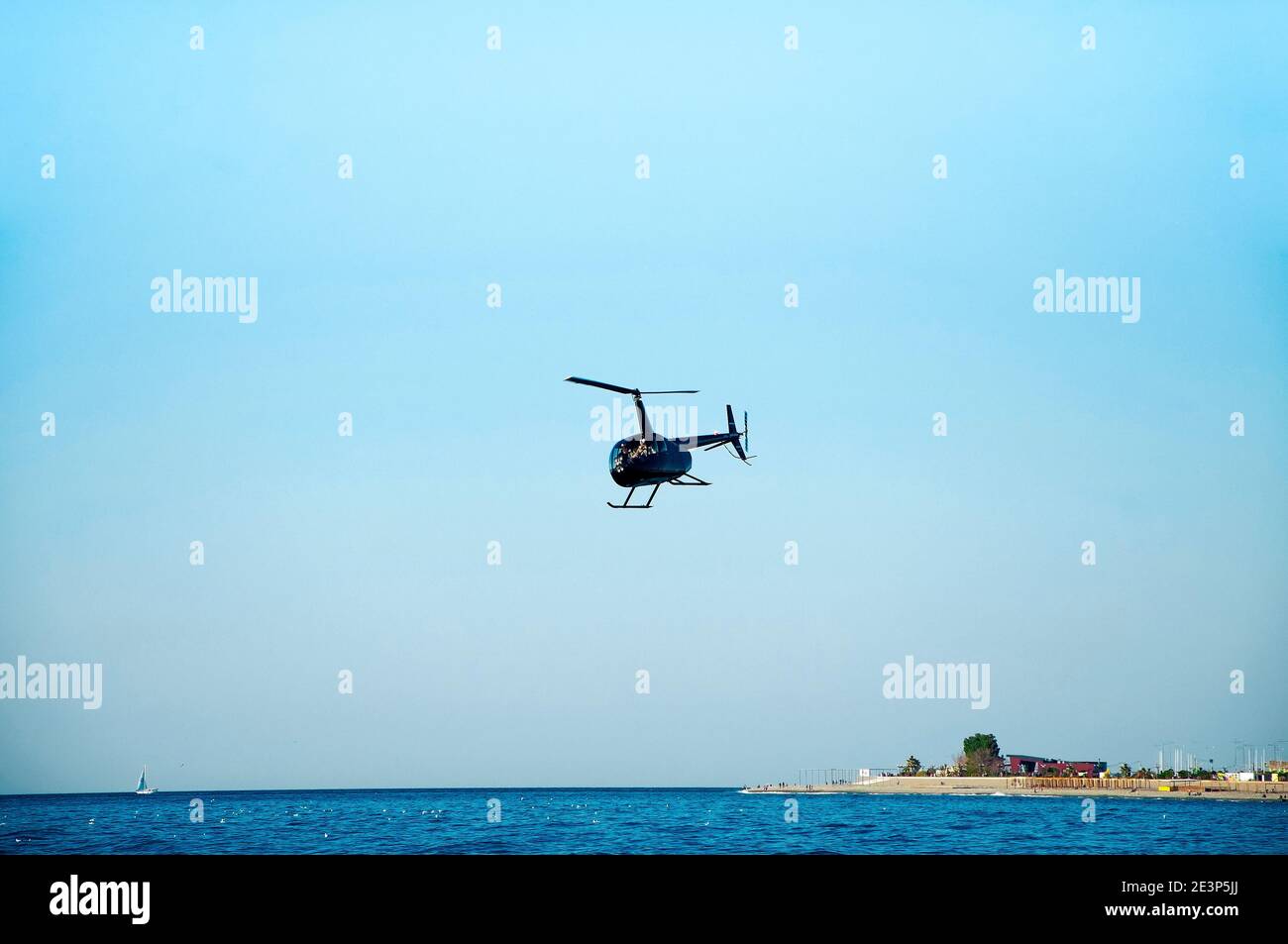 Helicopter is flying low over the sea Stock Photo Alamy