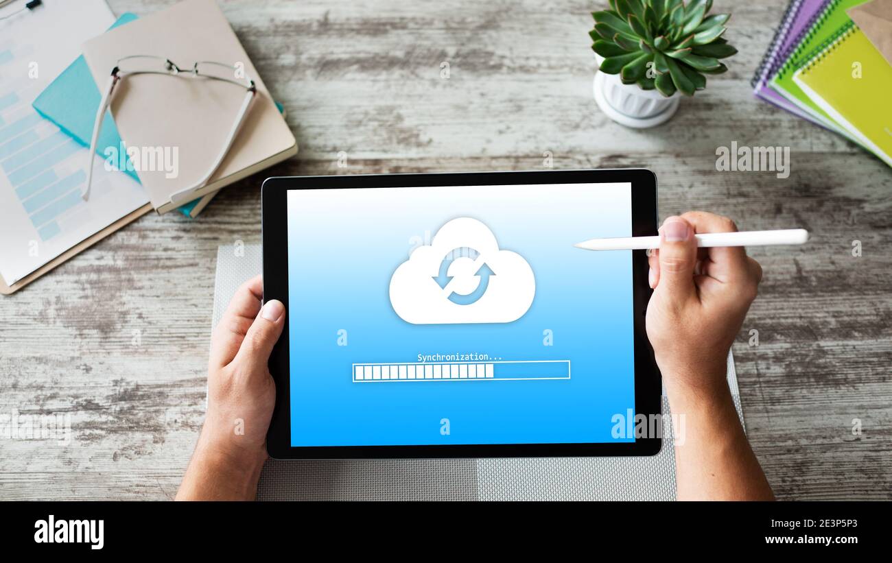 Cloud synchronization progress bar on tablet screen. Data storage and protection. Technology and internet concept Stock Photo