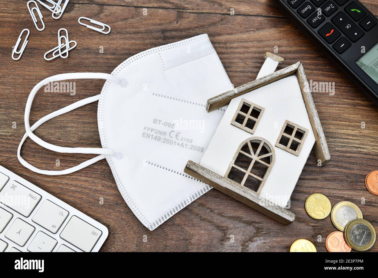 Face mask and miniature house, home office Stock Photo