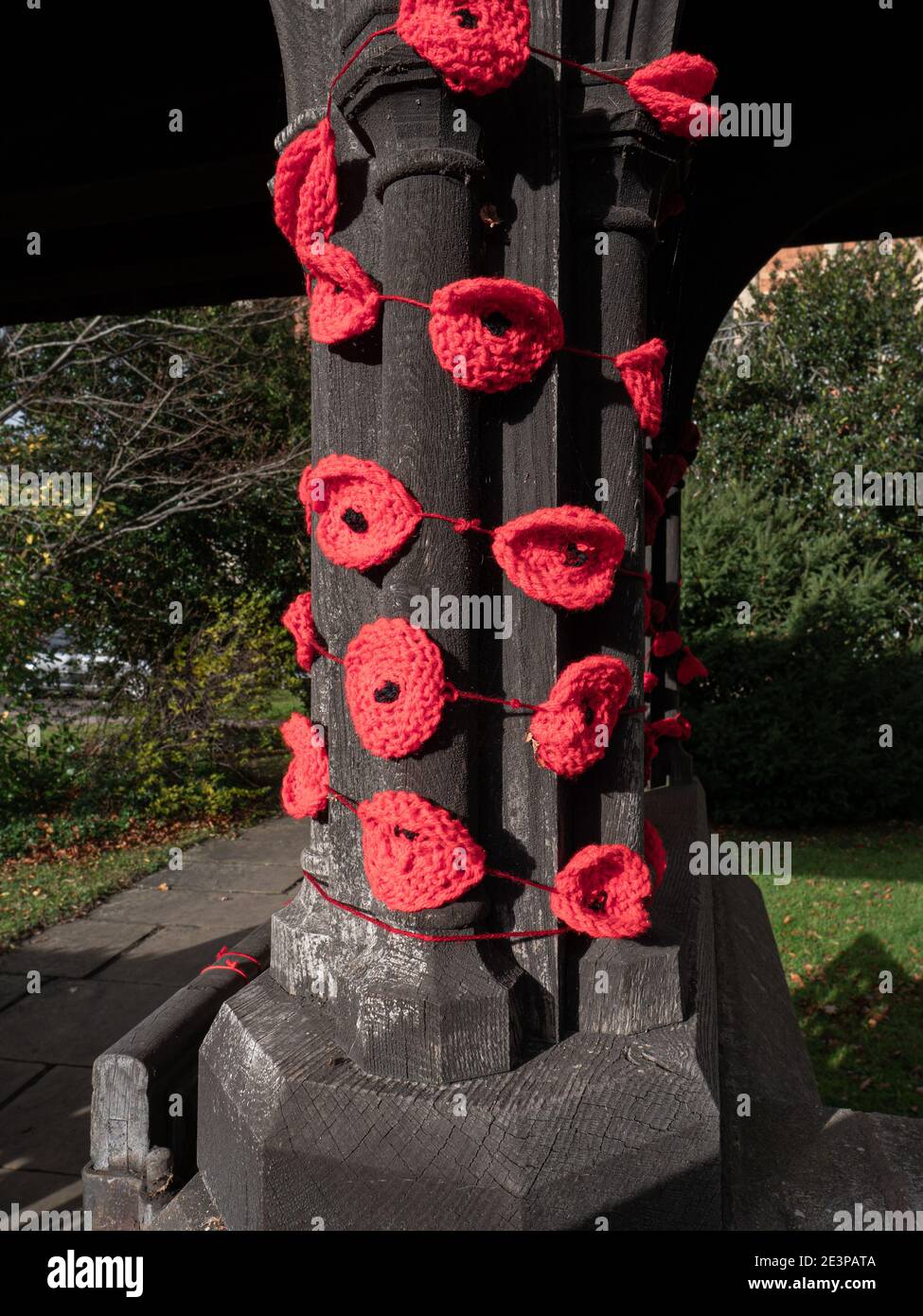 Knitted poppy flowers attached to church columns for remembrance day