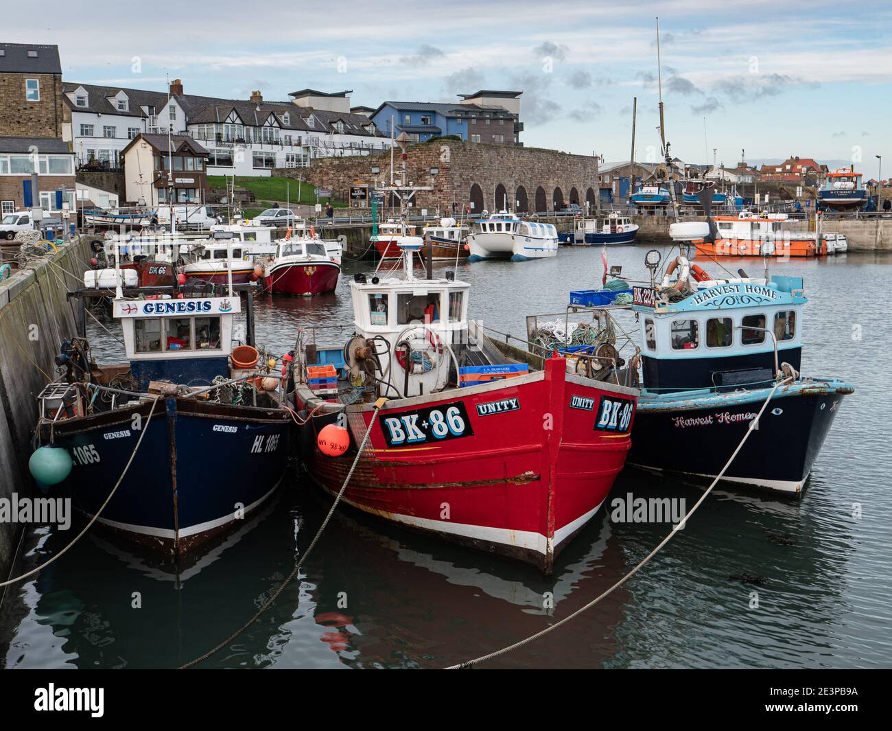 Fishing boats moored in Seahouses harbour in Northumberland England UK