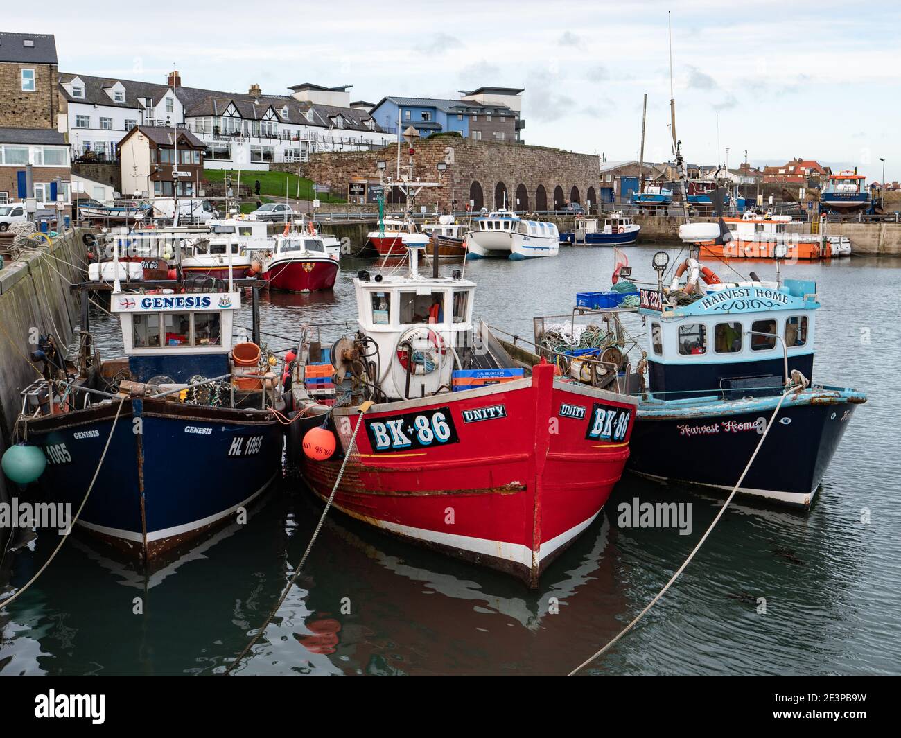 Fishing boats moored in Seahouses harbour in Northumberland England UK ...