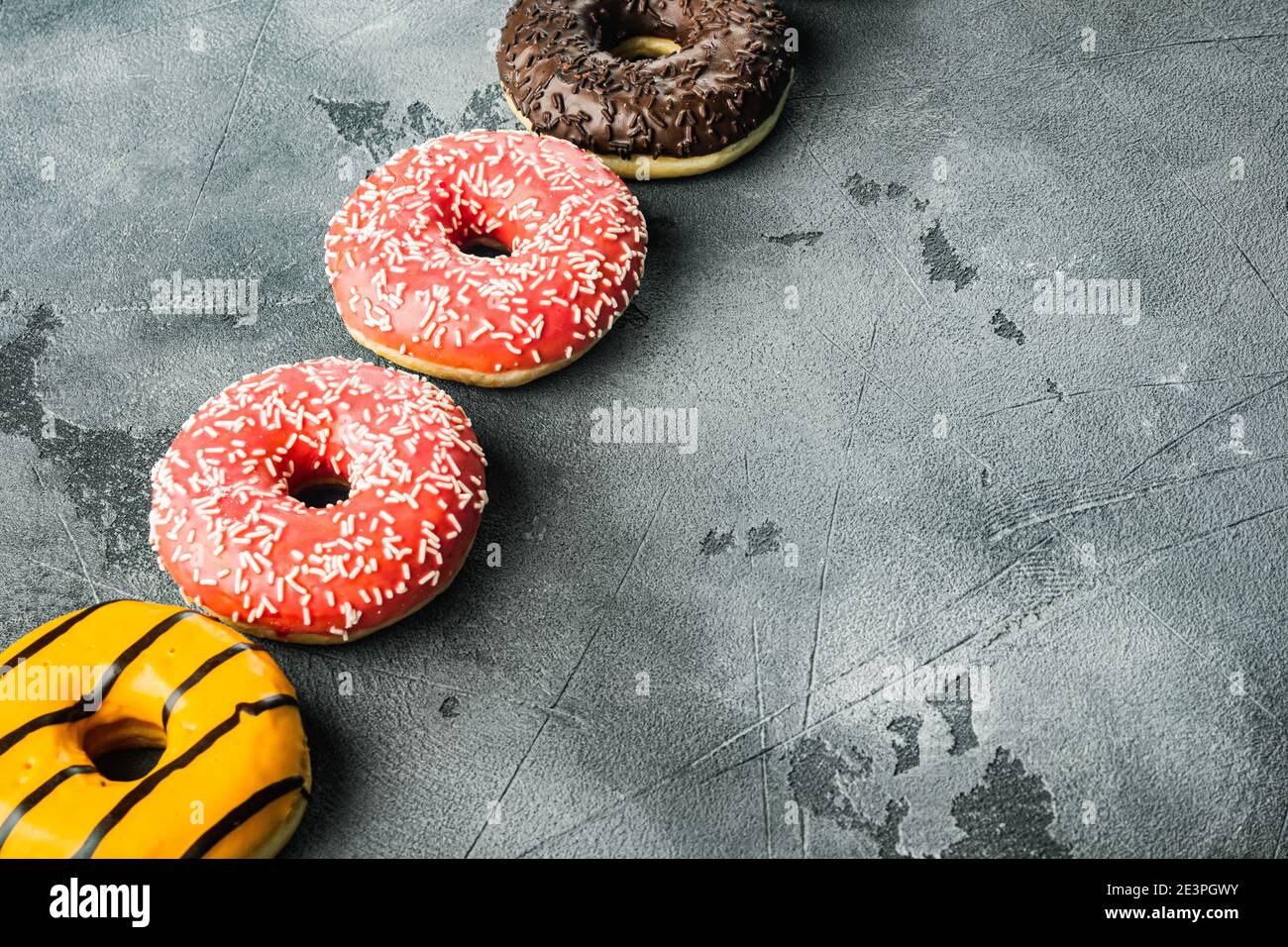Delicious glazed donuts set, on gray background with copy space for text Stock Photo