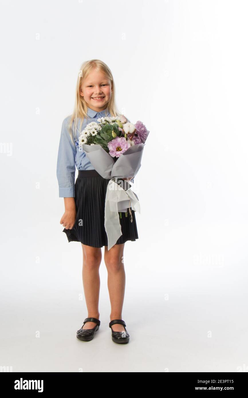 Studio portrait of cute blonde girl in school uniform with beautiful ...