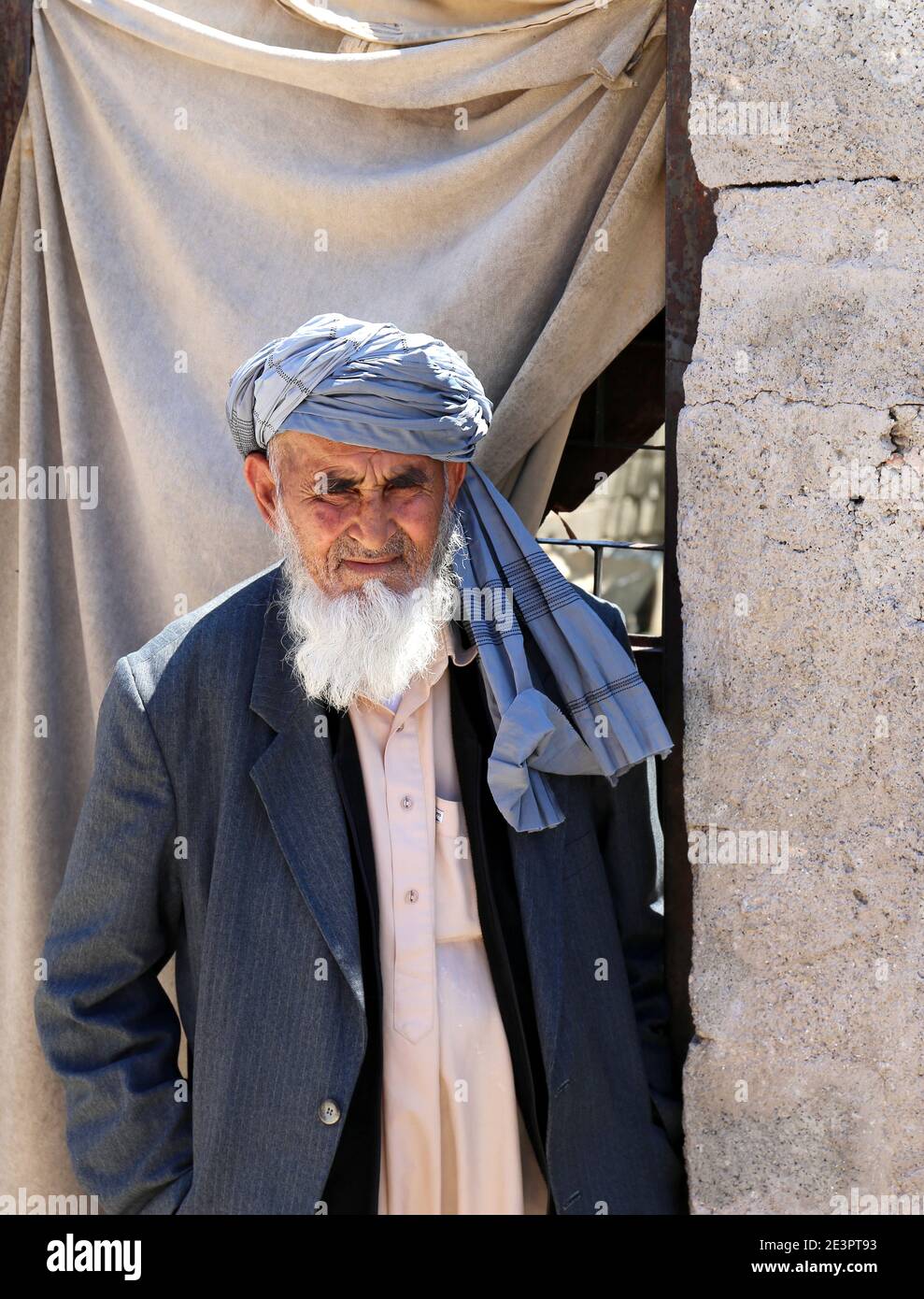 OVAKENT,HATAY,TURKEY-JUNE 3:Religious Afghan Man with long beard standing and posing in front of his house.June 3,2017 in Ovakent,Hatay,Turkey. Stock Photo