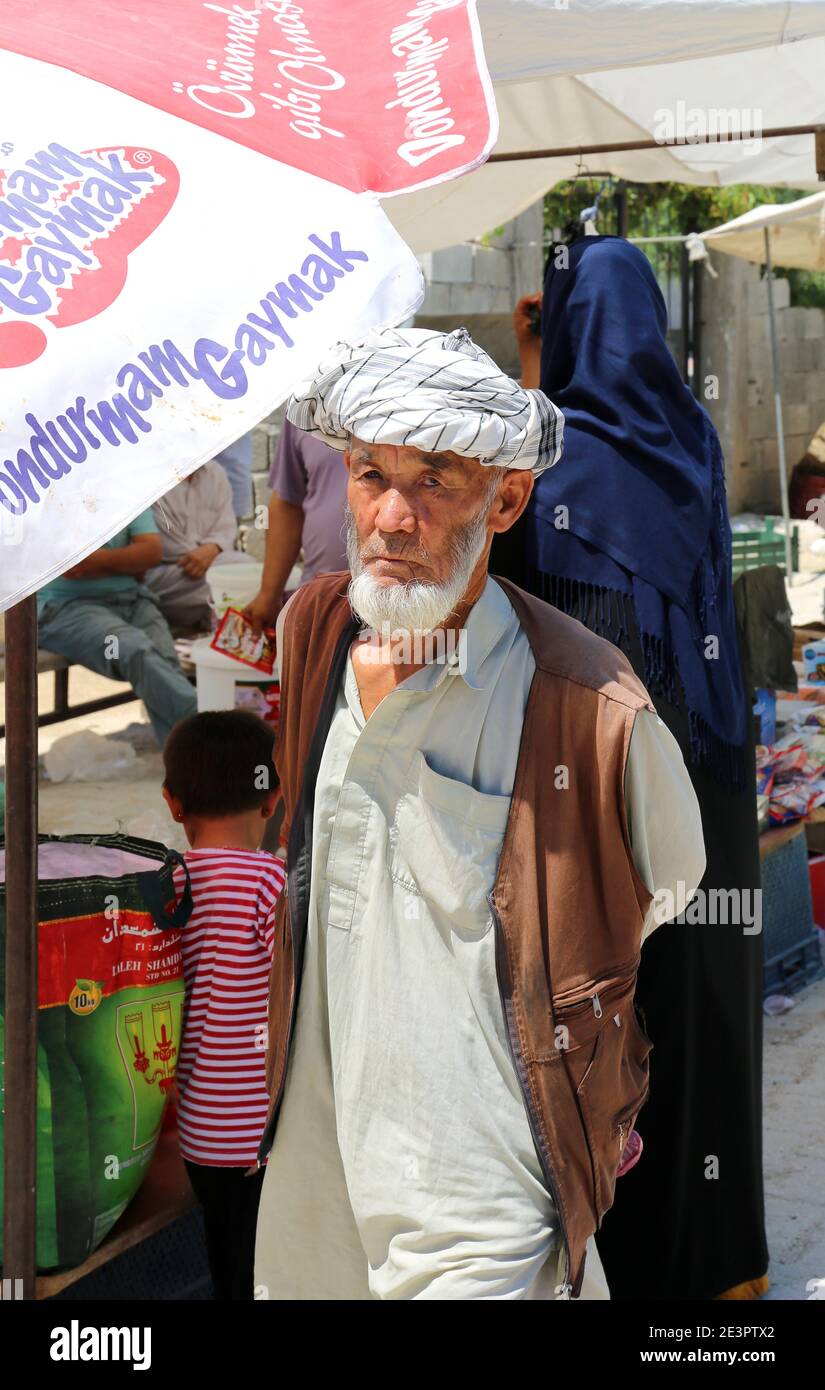 OVAKENT,HATAY,TURKEY-JUNE 3:Unidentified Afghan Man walking at farmers market.June 3,2017 in Ovakent,Hatay,Turkey. Stock Photo