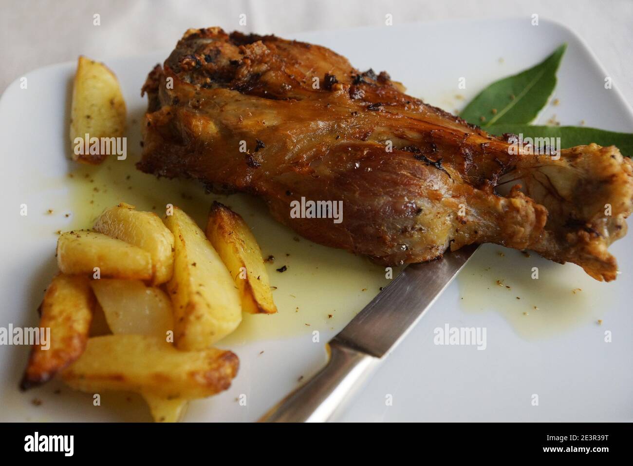 A ham hock (or hough) or pork knuckle with French fries Stock Photo